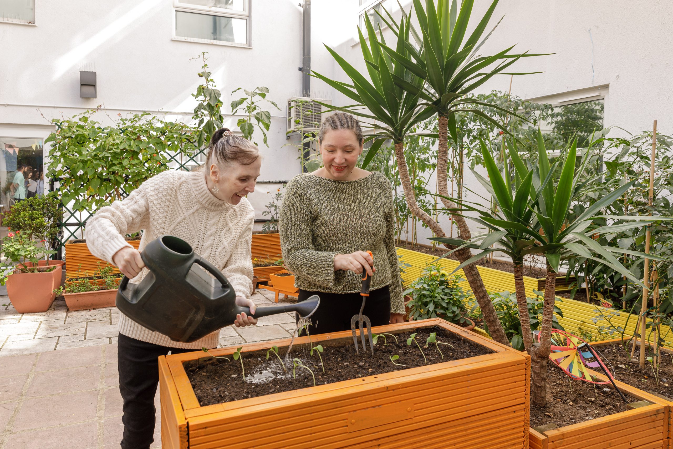 Two people watering plants